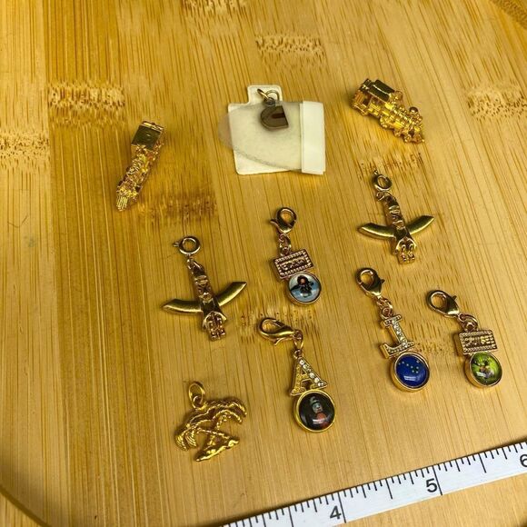 Set of 9 gold plated charms and one 1/5g 10k gold charm with a total wt of 24g - Picture 5 of 16